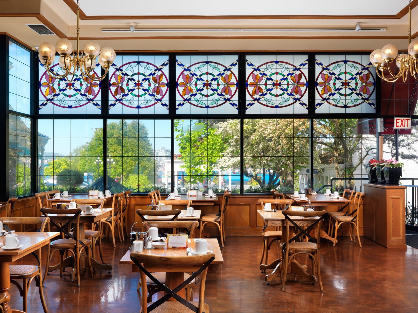 Elegant dining area with wooden interior, overlooking the garden in Hunter Restaurant at Huntingdon Manor 