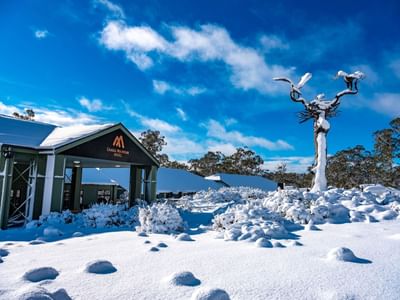 Exterior view with snow around the Cradle Mountain Hotel