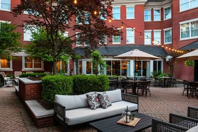Harbor Bistro Terrace surrounded by lush greenery at Portland Harbor Hotel