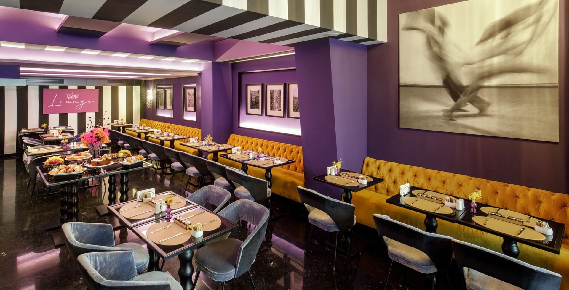 Breakfast area at Tribune Hotel Rome with modern décor, velvet seating and stylish artwork