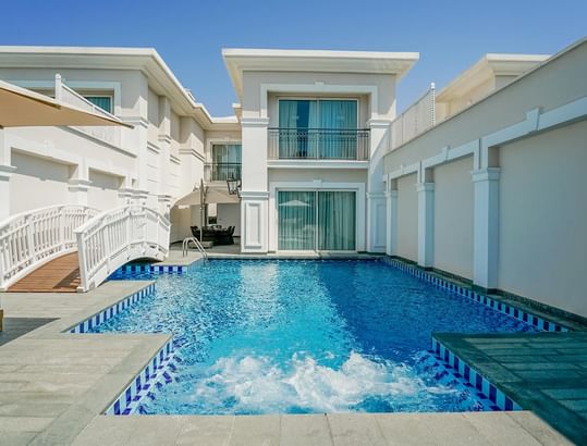 Exterior view of the Design Pool Villa and the outdoor pool at Titanic Deluxe Golf Belek