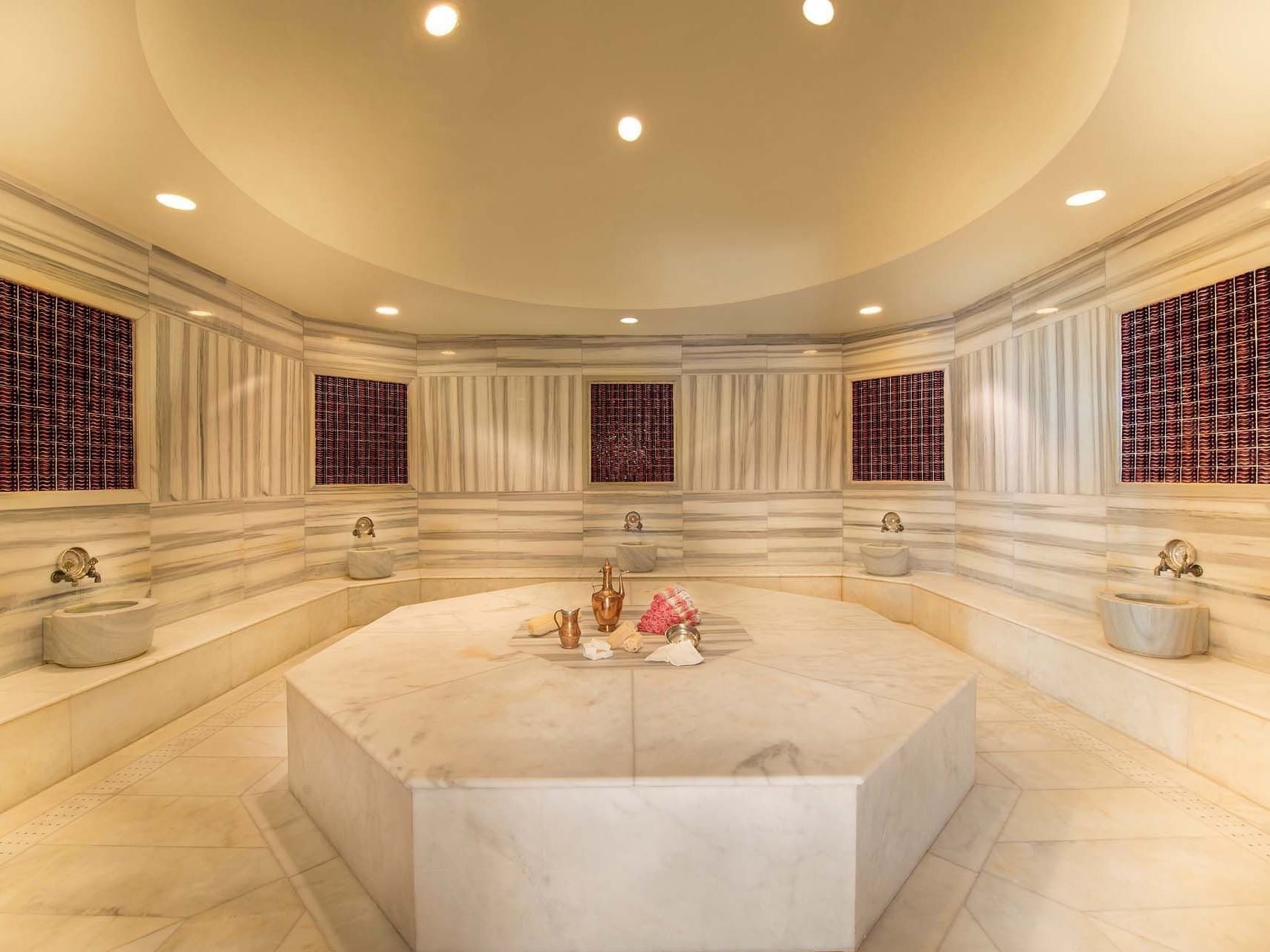 Hot stone bed around with stone benches in BeFine Spa at Titanic Deluxe Lara