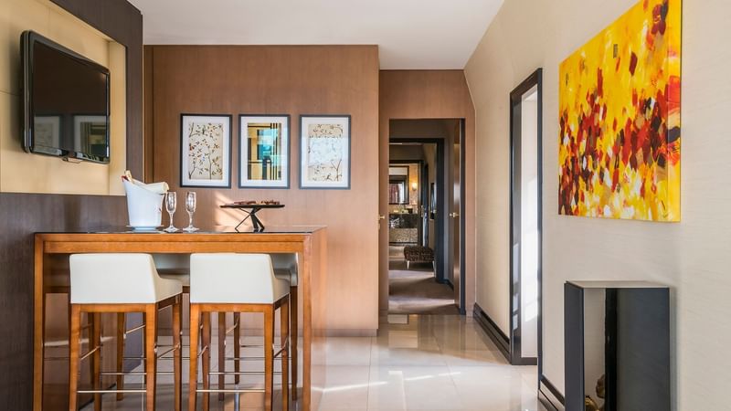 Dining area with high-top table and stools in Grand Place Suite at Warwick Brussels