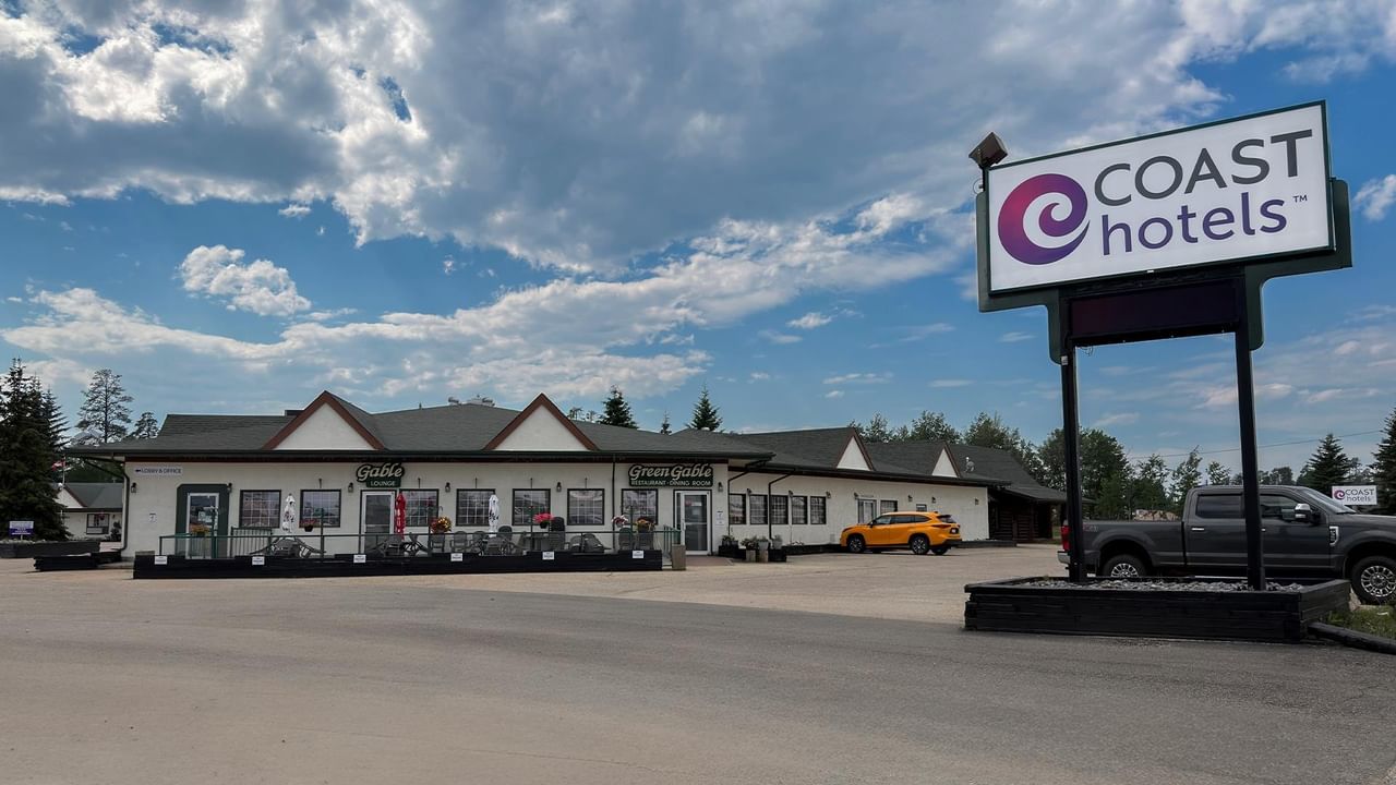 Exterior of Coast Whitecourt Hotel property under a partly cloudy sky