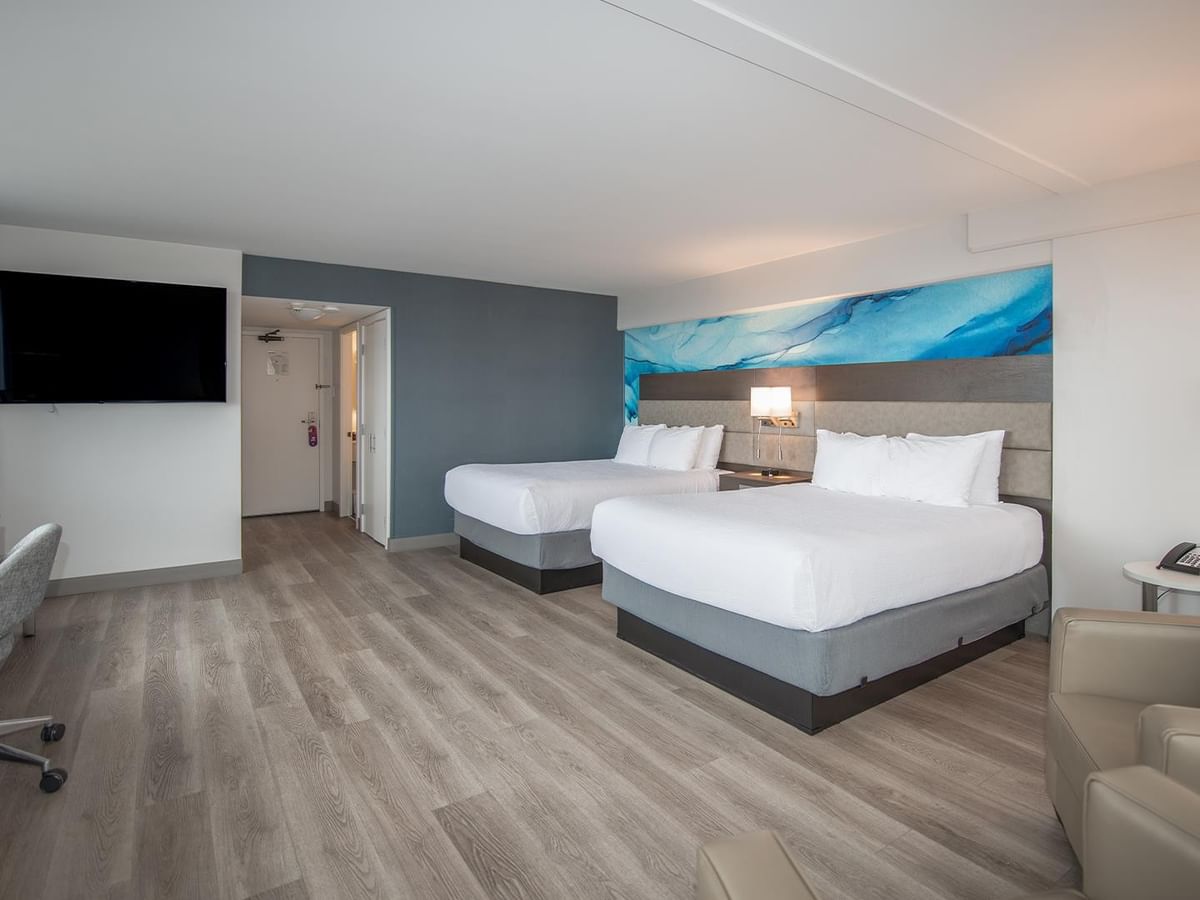 Two queen beds in a modern hotel room with ocean view at Coast Bastion Hotel in Nanaimo.