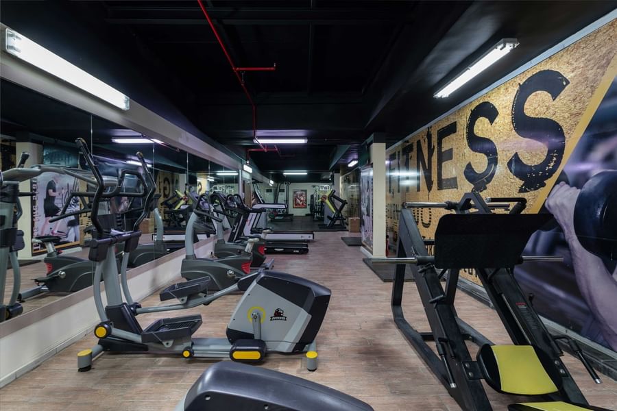Modern gym with treadmills, ellipticals, and strength machines at Warwick Hotel Jeddah