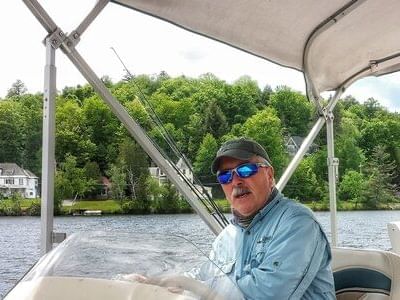 Guide of Stillwater Guide Service on a boat, High Peaks Resort