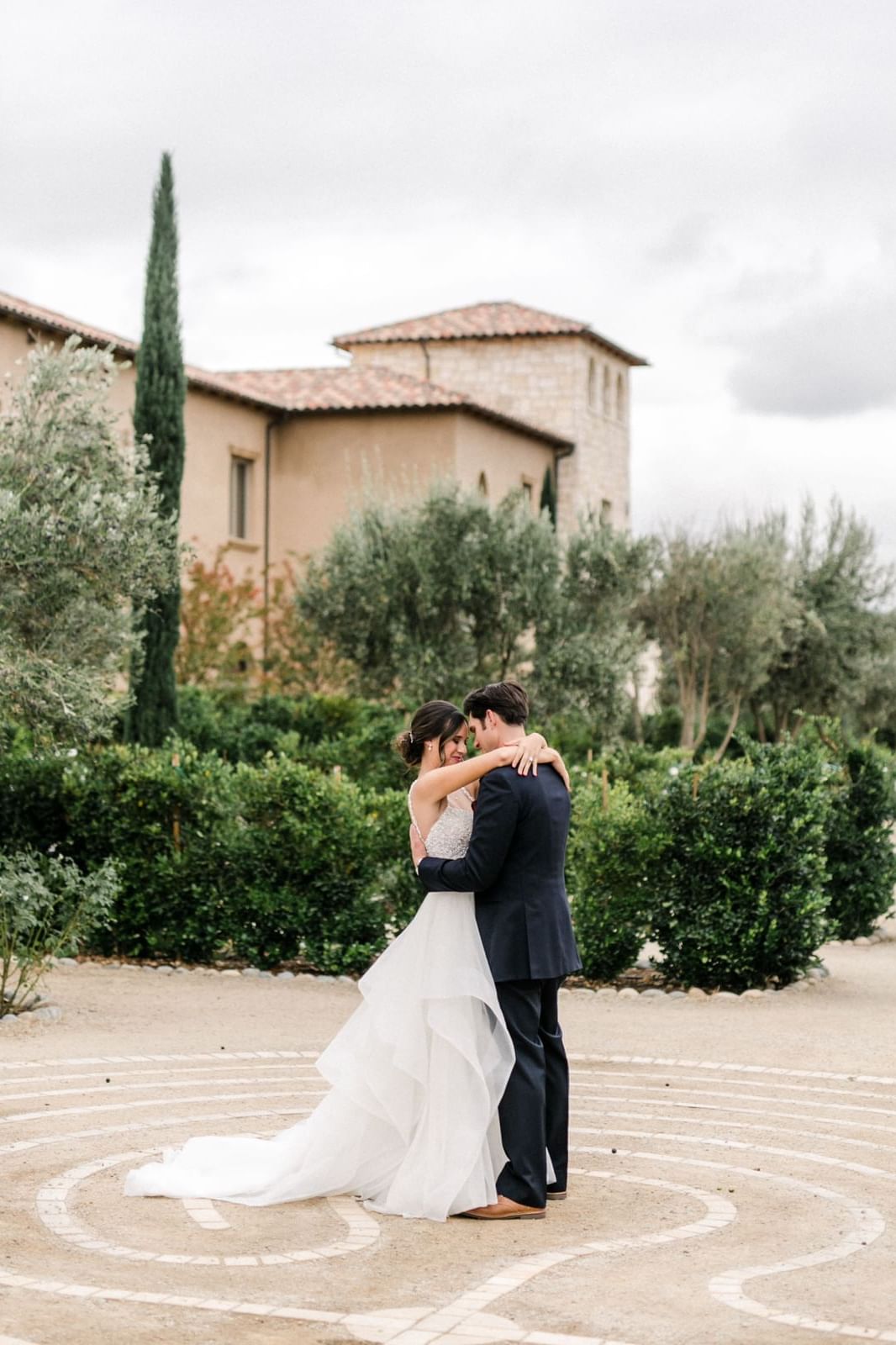 Anna Delores (www.annadelores.com) Bride with her arms around the groom dancing