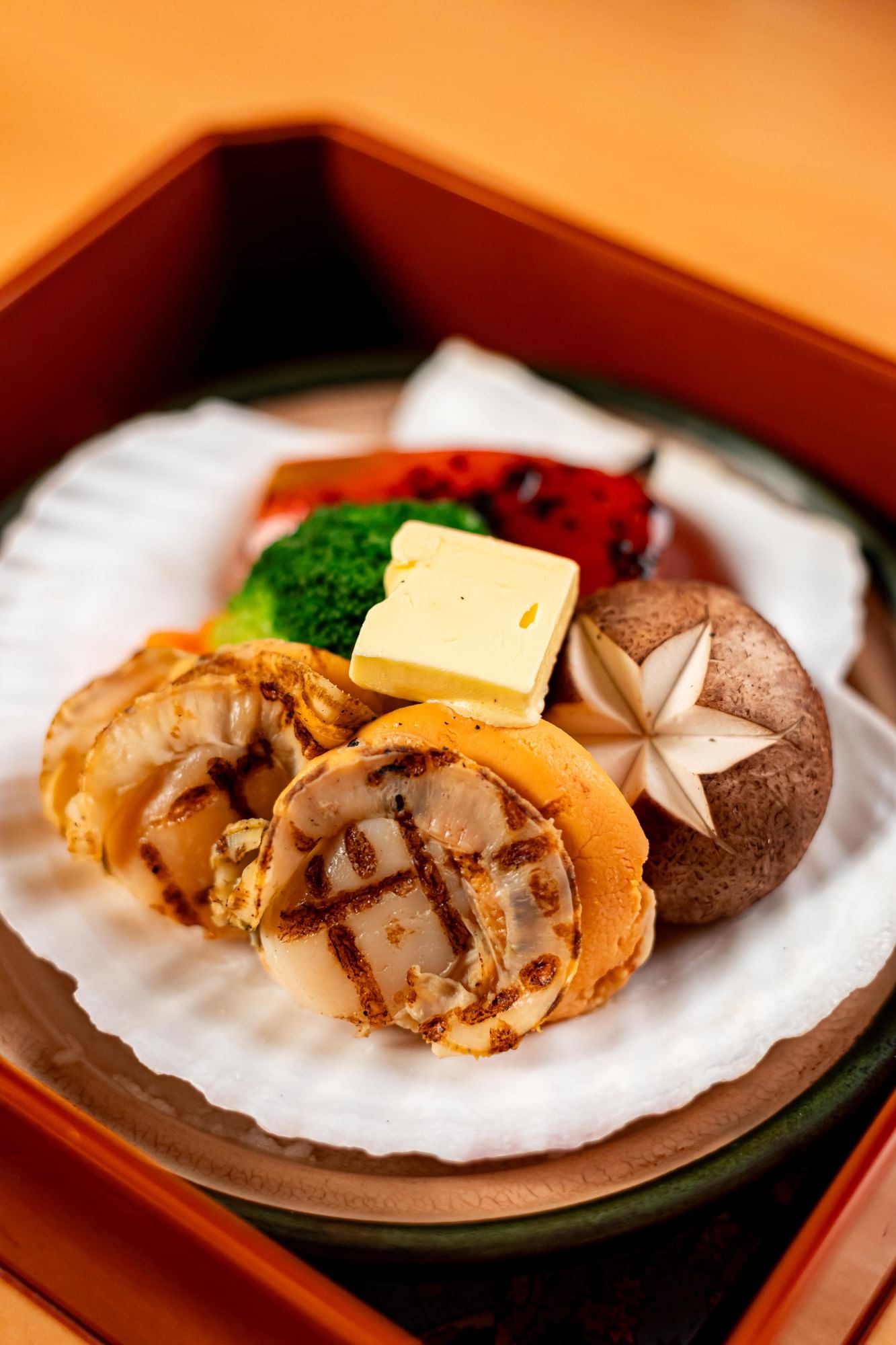 An overhead view of a traditional Japanese lacquered bowl containing fresh chirashi sushi at Hotel Okura Manila
