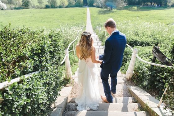 Wedding couple walking in outdoor stairs near Richmond Hill