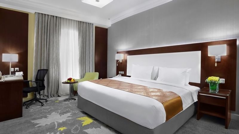 King bed and working area Family Suite with carpeted floors at Warwick Hotel Jeddah