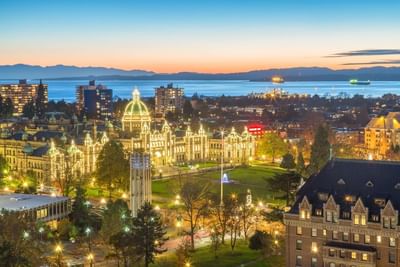Evening aerial view of Victoria's illuminated parliament building and waterfront, near the Embassy Inn Victoria