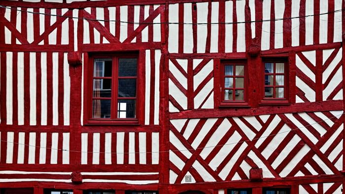 Red striped wall of a building of Giverny near Originals Hotels