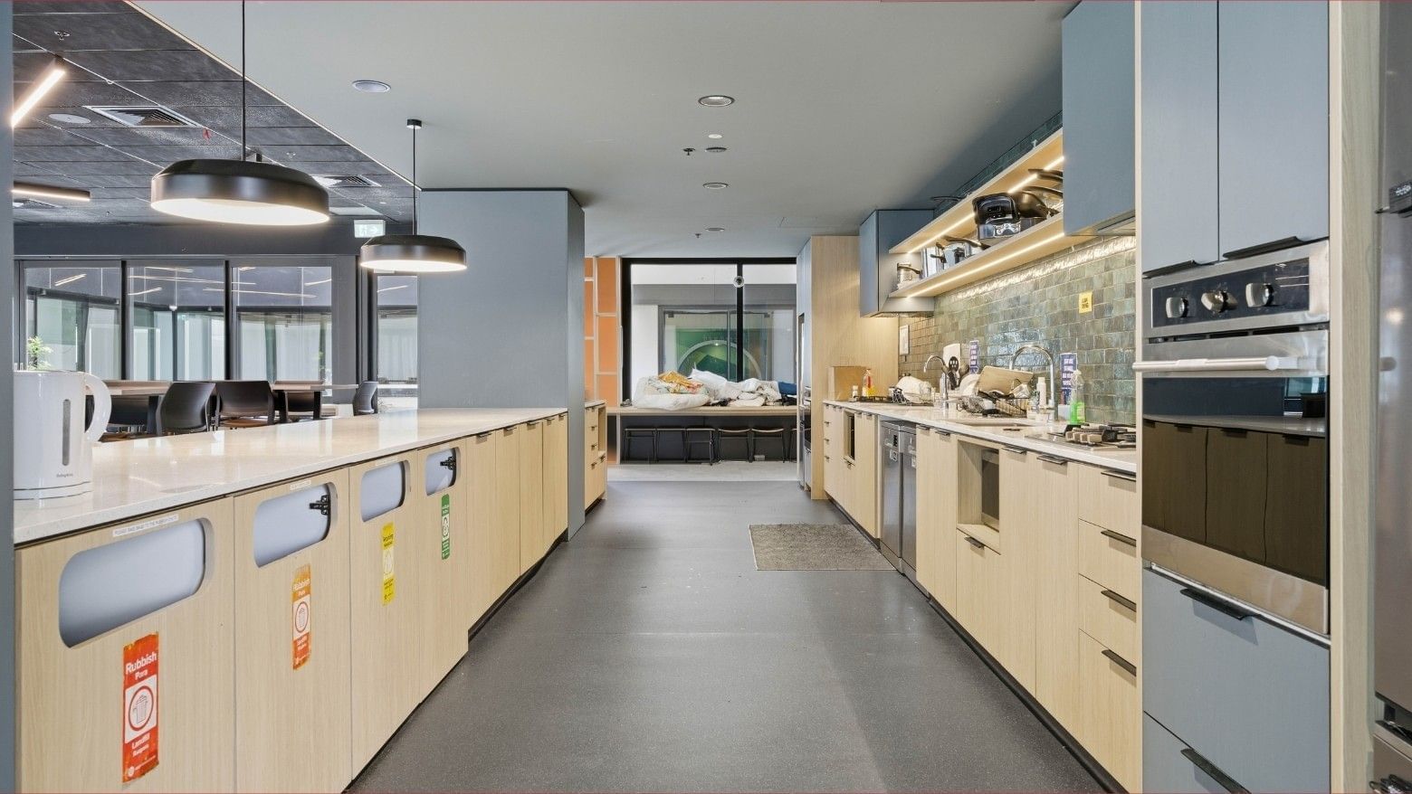 Modern kitchen with white countertops and wooden cabinets at Mayoral Drive Student Accommodation.