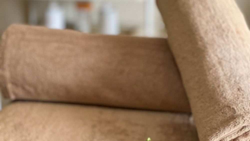 Towel and flowers on a spa bed at The Joy Spa in The Naviti Resort, Korolevu.
