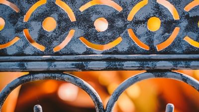 Blue textured wall with orange smiley face patterns above decorative metal railings at Hotel Montana Haiti