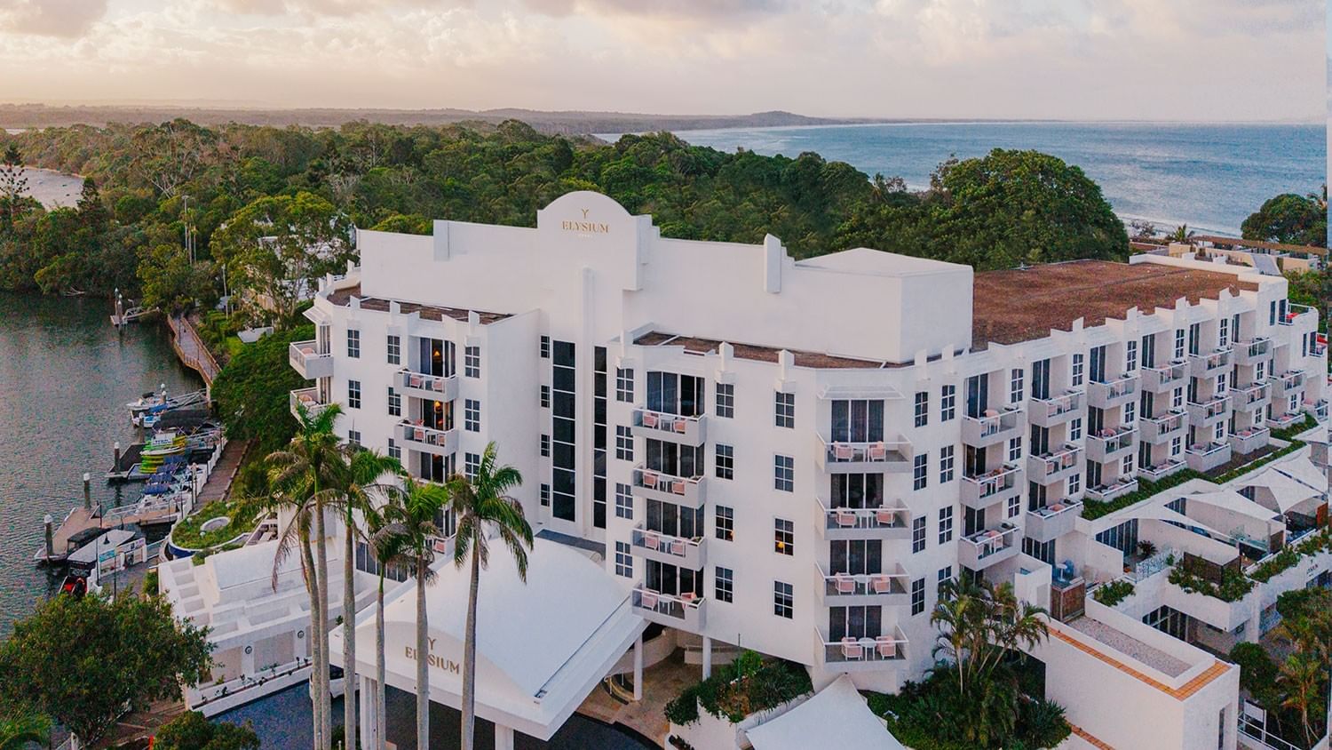 Aerial view of white multi-story Elysium hotel by the sea at Elysium Hotels