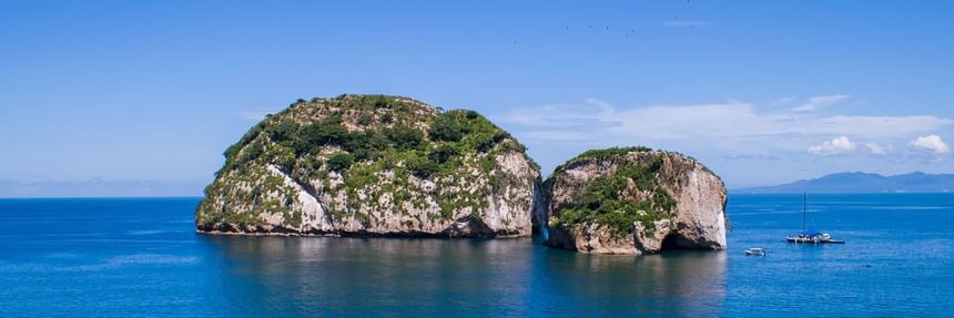Ocean view of Los Arcos Marine Park featuring rocky islands surrounded by deep blue waters near Casa Dona Susana