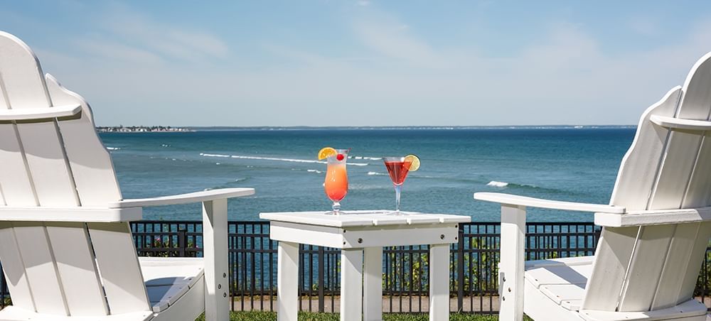 Cocktails served outdoors with a sea view at Ogunquit Collection