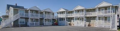 Exterior view of South Beach Apartments in Ocean City MD with a parking lot