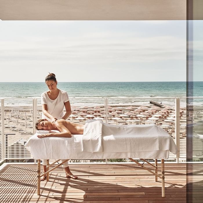 Lady receiving a massage on a spa balcony, Falkensteiner Hotels