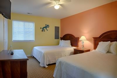 TV & side cupboard facing the beds in 2 Bedroom Apartment - 1 King Bed & 2 Double Beds at South Beach Apartments Ocean City