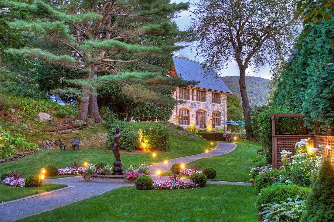 Beautiful evening view of the extensive gardens and illuminated walkways at Castle Hill Resort and Spa
