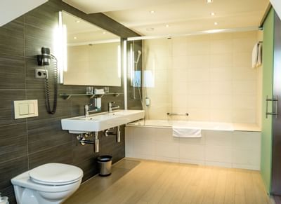 Interior of a bathroom with a bathtub at Hotel Sternen Oerlikon