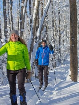 Couple walking down a forest hiking trail in Winter near Cove Pocono Resorts