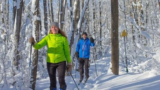 Couple walking down a forest hiking trail in Winter near Cove Pocono Resorts