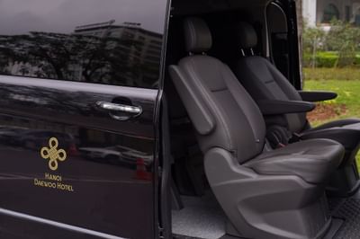 A van with an open door & the seats visible at Hanoi Daewoo Hotel