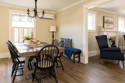 Spacious dining and living area with cozy seating and wooden flooring in Robins House at Rodd Grand Yarmouth