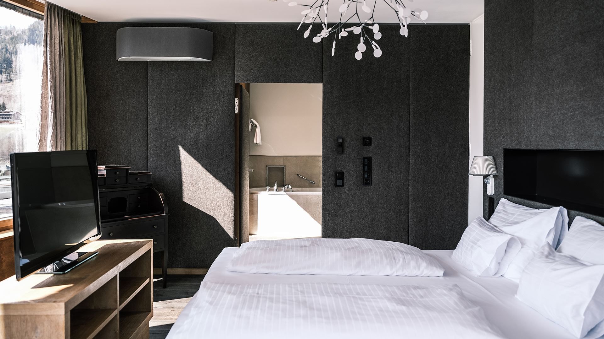 Large bed in Dachstein Suite at Falkensteiner Hotels