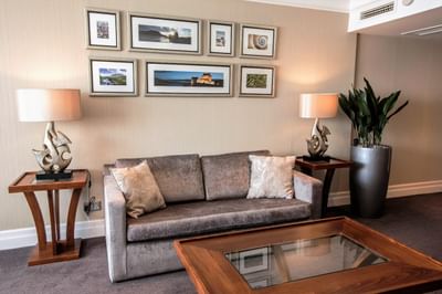 Suite Lounge area at The Aberdeen Altens Hotel with a plush grey sofa and a collection of framed wall art