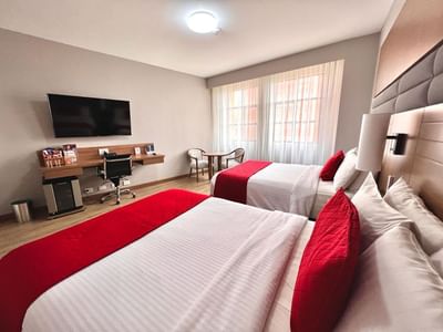 Business Carlton Twin featuring twin beds, a desk, and a chair at Dann Carlton Cali, one of the top hotels in Cali Colombia