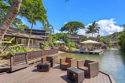 Outdoor lounge area on a deck by the Bay at Paradise Bay Resort