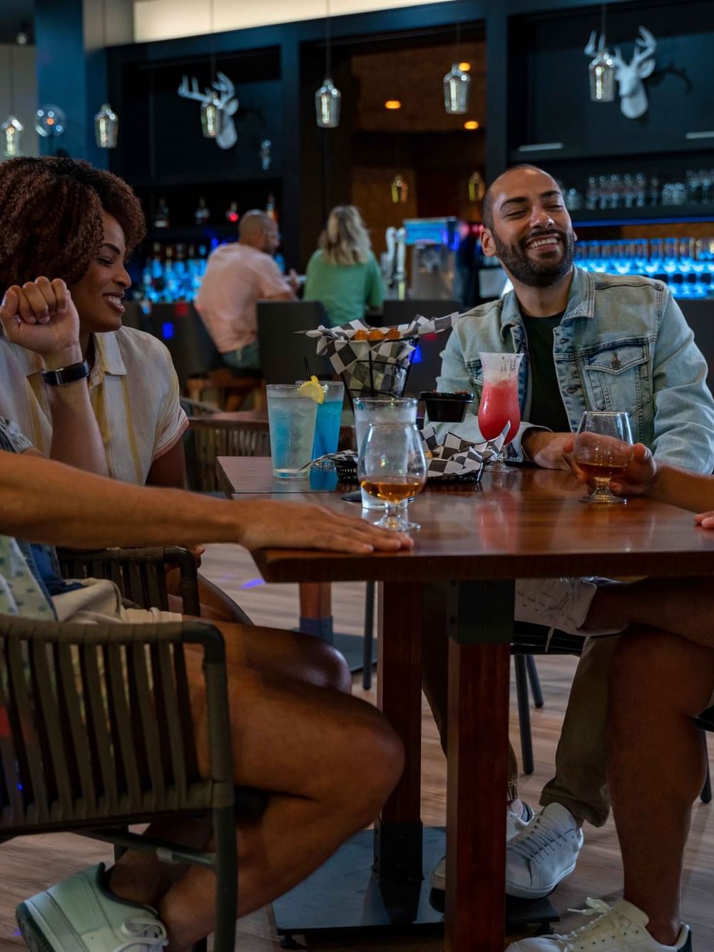 Group of friends enjoying each others company in a table in Spooner's Grill at Cove Pocono Resorts
