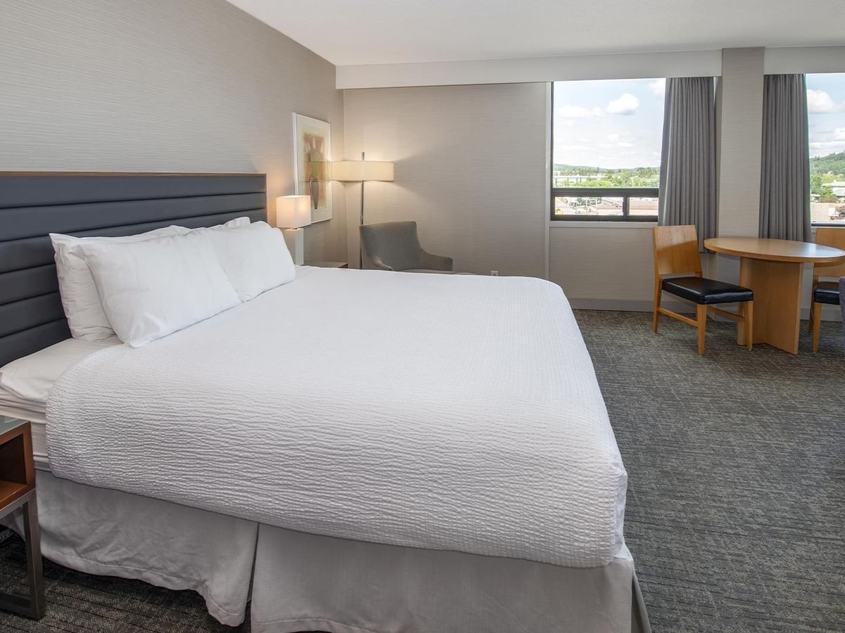Coast Premium King Junior Suite with king bed, seating area, and city views at Coast Prince George Hotel