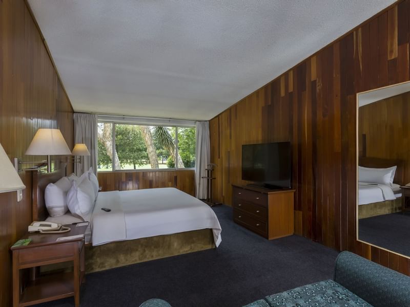 Interior of Junior Suite with king bed & TV at Gamma Hotels