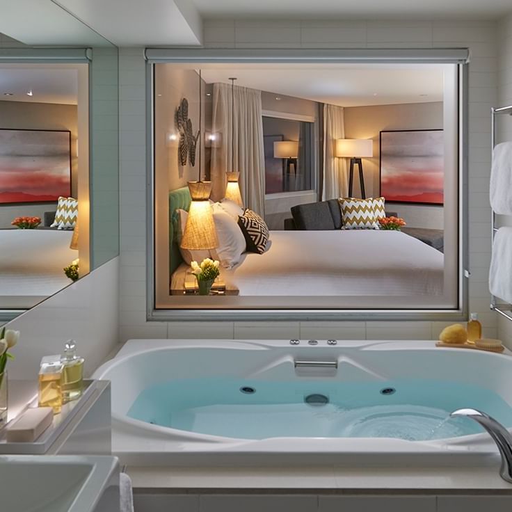 Bathtub with a mirror in Spa Studio Room at Crown Hotel Perth