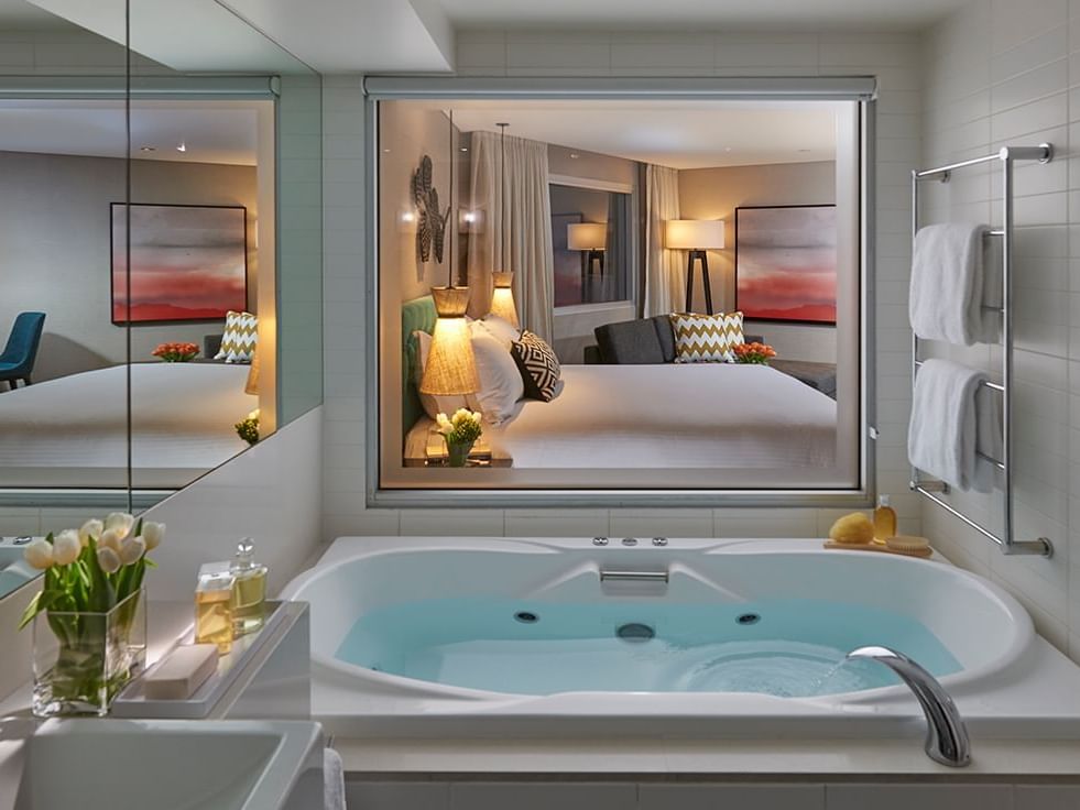 Bathtub with a mirror in Spa Studio Room at Crown Hotel Perth