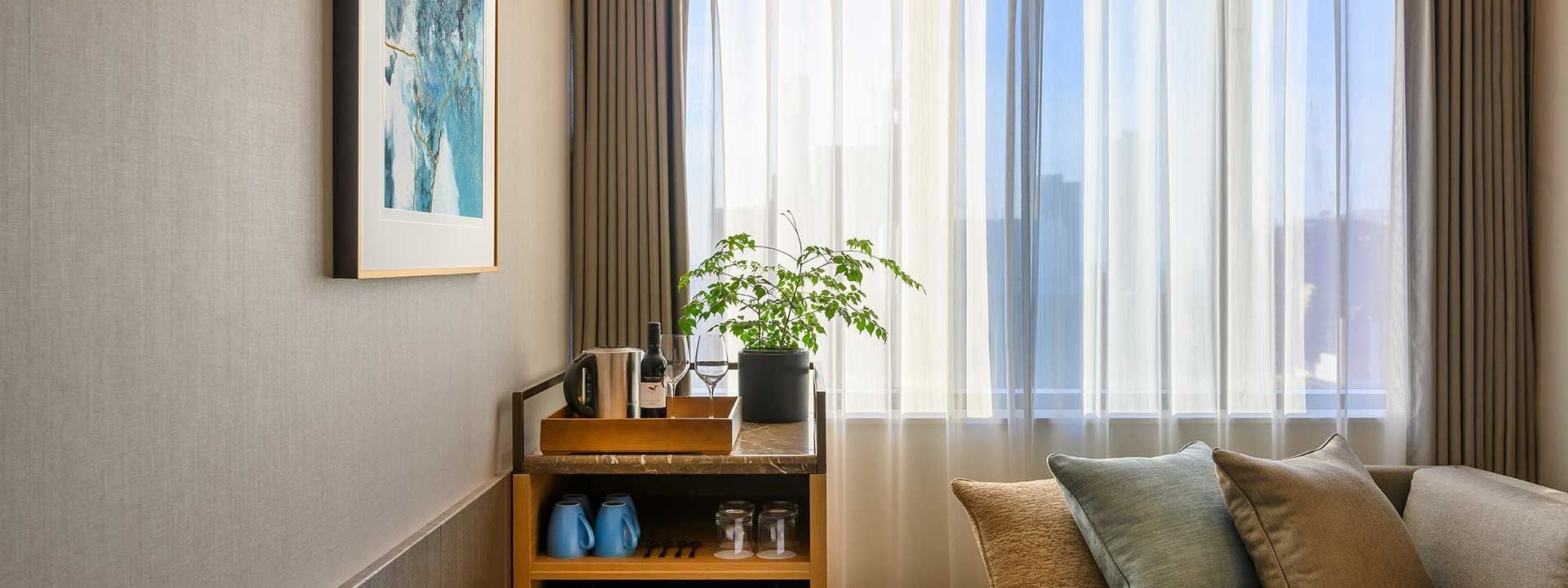 Mini bar & sofa in Deluxe Room at Melbourne Central Hotels