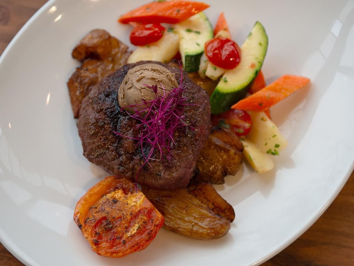 Plate of steak and vegetables at Minnoz Restaurant + Lounge, Coast Bastion Hotel in Nanaimo.