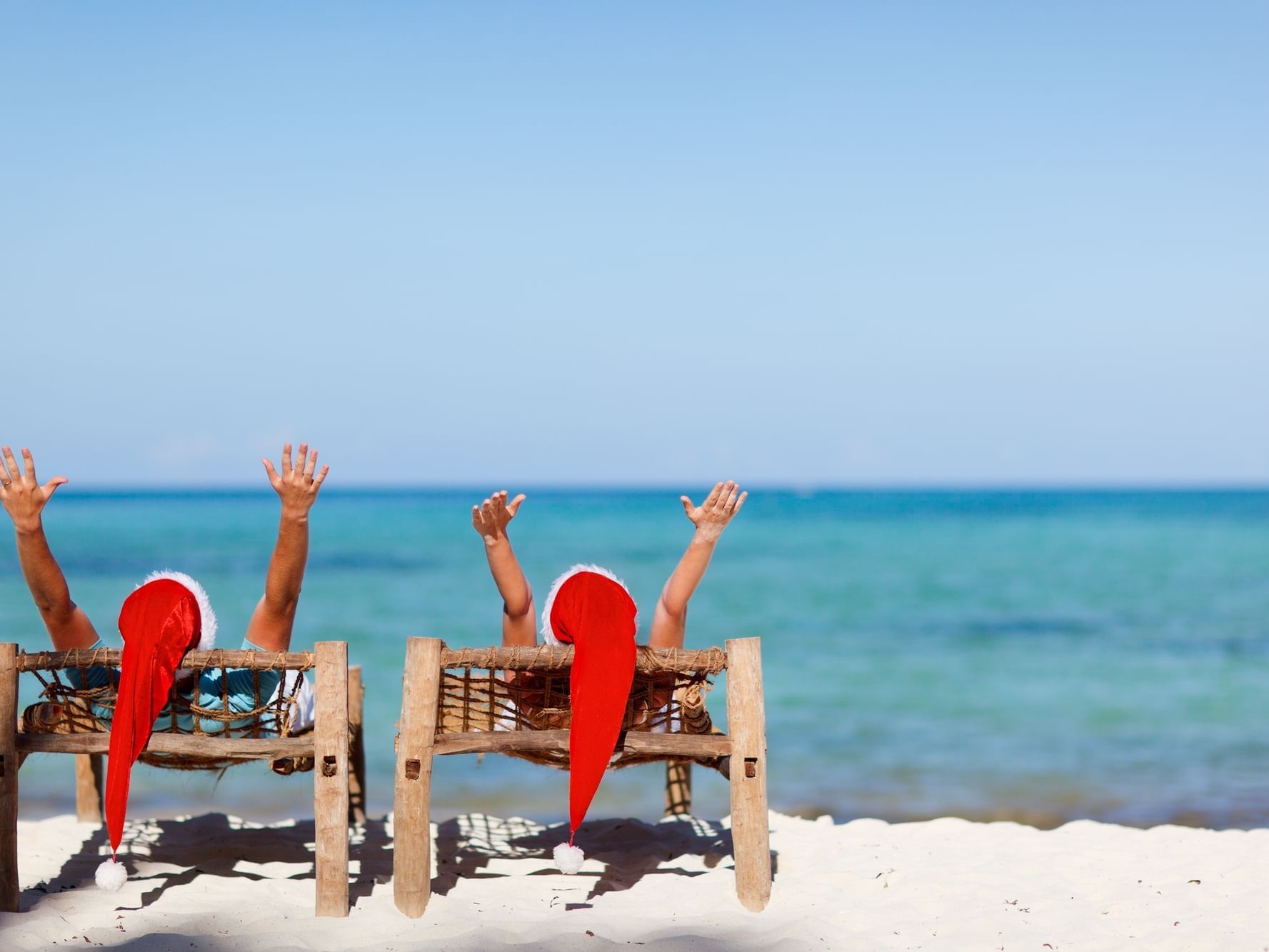 Couple posing with Santa hats on at Daydream Island Resort