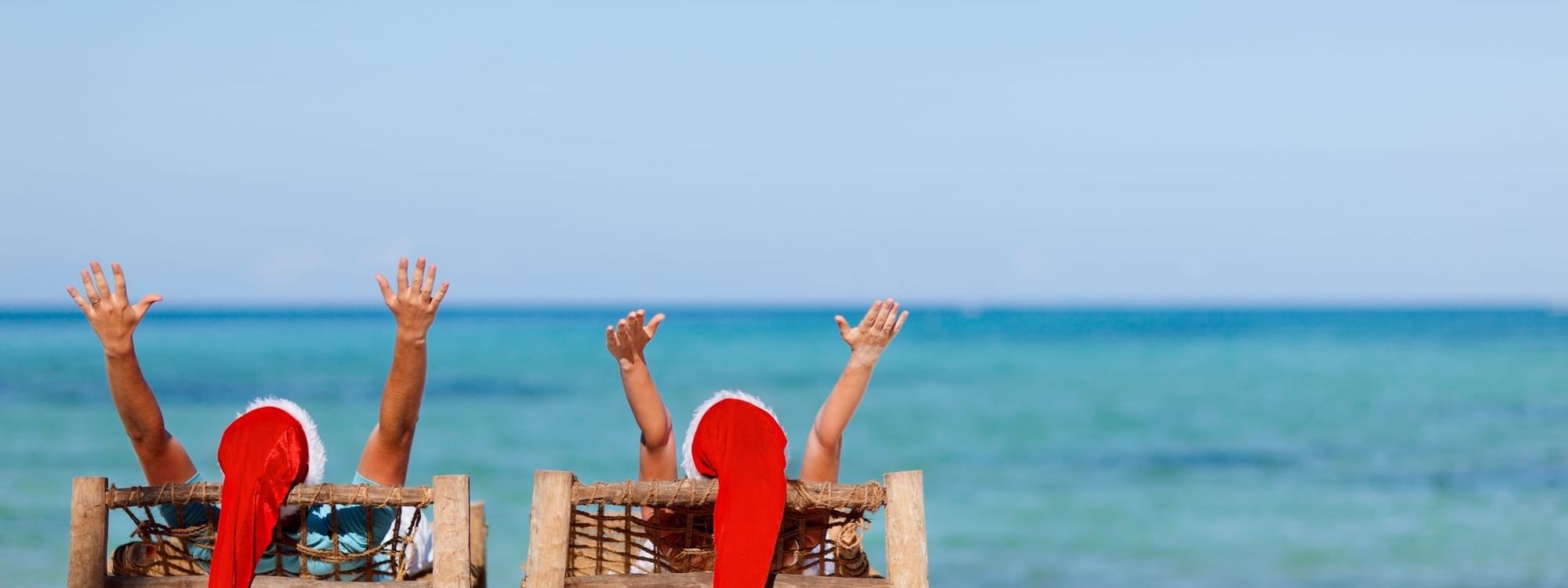 Couple posing with Santa hats on at Daydream Island Resort