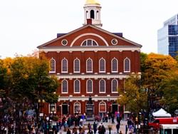 a group of people in front of a red building