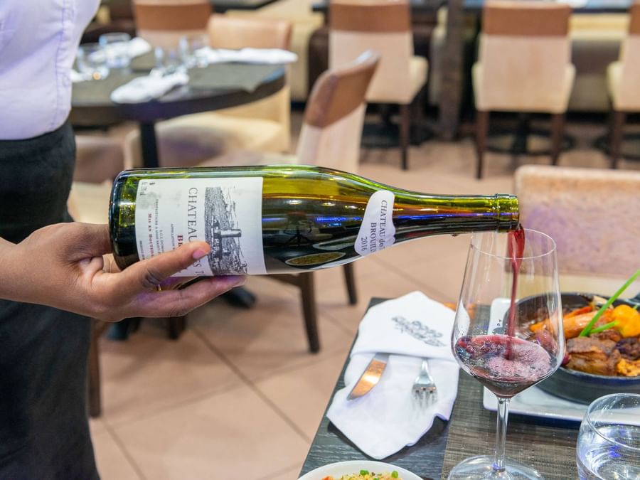 Pouring wine to a glass closeup at Hotel Belova