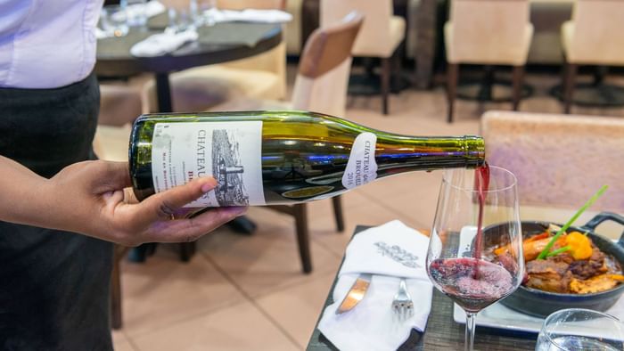 Pouring wine to a glass closeup at Hotel Belova