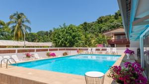 Outdoor pool with sunbed area at Originals Hotels