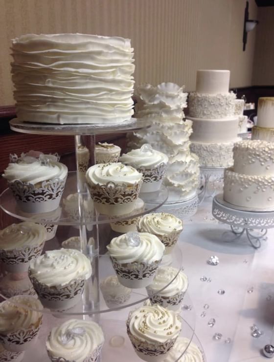 Wedding cake and cupcake platters with decorations at The Glenmore Inn & Convention Centre